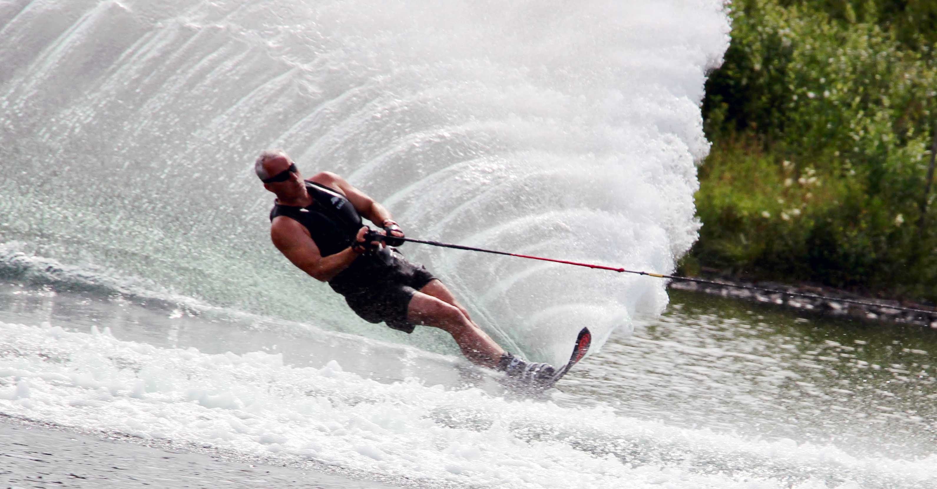 Mike Royal completes a turn creating a large spray of water while slalom waterskiing at the 2019 IWWF World Disabled Waterski Championshipsheld in Norway.  